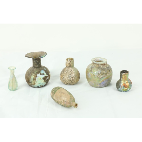 851 - A collection of 6 antique Roman coloured glass Vessels, of various size, shape and form, as antiquit... 