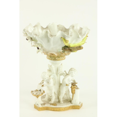 920 - A Moore Brothers porcelain Centerpiece, the bowl encrusted with flowers on a stand with three cherub... 