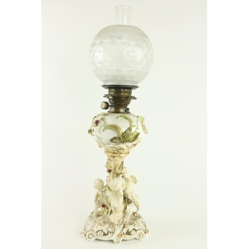 922 - A fine quality Moore Brothers porcelain Oil Lamp, Reg. No: 16446, with flower encrusted reservoir on... 