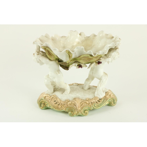 929 - A Moore Brothers porcelain oval Centerpiece, the bowl encrusted with flowers and supported by two ch... 