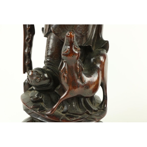 170 - A Chinese carved cherrywood Figure, of Shou Xing (God of Longevity) leaning on the 