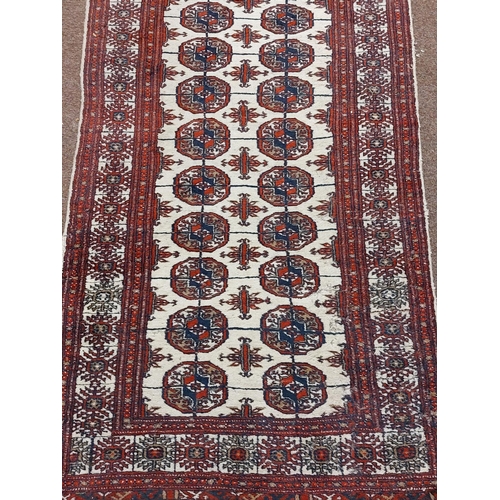 192 - An antique style woollen Carpet Runner, the cream ground centre with double line circular motif with... 