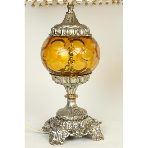 273 - An embossed brass Table Lamp, the two stage body with classical figures in relief supporting an ivor... 