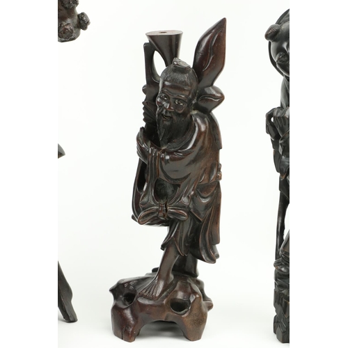 281 - A Japanese carved root wood Figure, Meiji c. 1900, depicting a deity standing on one leg on an intri... 