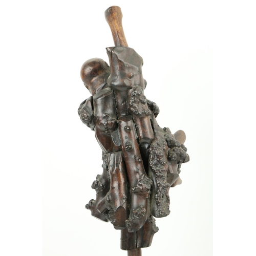 281 - A Japanese carved root wood Figure, Meiji c. 1900, depicting a deity standing on one leg on an intri... 