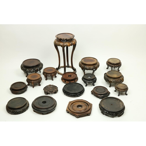 317 - A collection of Chinese cherrywood and other wooden Stands, of different sizes and height, all decor... 