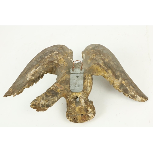 369 - An 18th Century carved giltwood Wall Applique, modelled as an eagle perched on an oval, 9