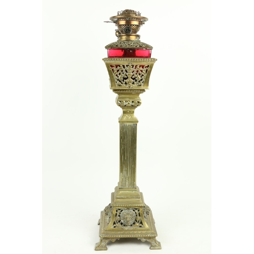 375 - A very unusual late 19th Century brass Oil Lamp, with ruby glass reservoir cut in a pierced basket o... 