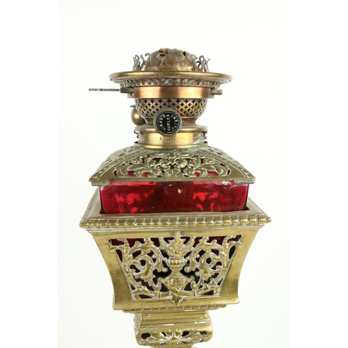 375 - A very unusual late 19th Century brass Oil Lamp, with ruby glass reservoir cut in a pierced basket o... 