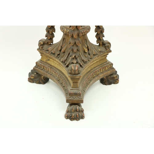 410 - A giltwood Georgian style Torchere, with floral decoration and drapes on a triform base with paw fee... 