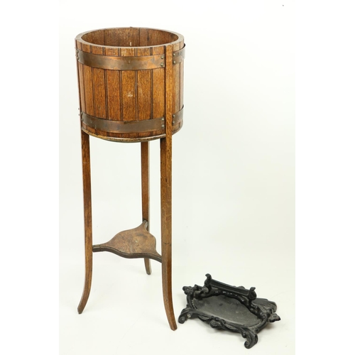 496 - A heavy cast iron black painted Footscrapper, together with an oak copper bound Plant Stand on three... 