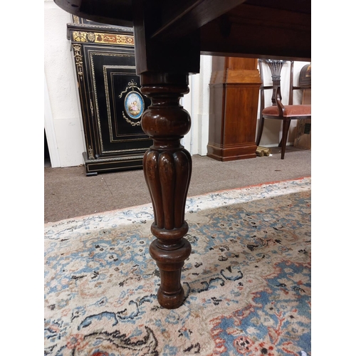 531 - A Victorian mahogany Dining Room Table, with deep moulded rim, on four baluster fluted and lobed leg... 