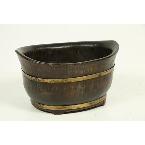 1034 - A 19th Century Provincial wood dug-out canoe shaped over-sized Bowl, with double brass band on shape... 