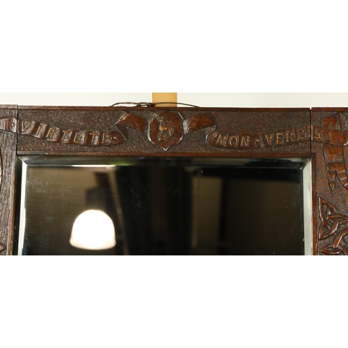 1036 - A Celtic carved oak Wall Mirror, crested and with the motto 'Virtule Non Verbis' on a ribbon design,... 