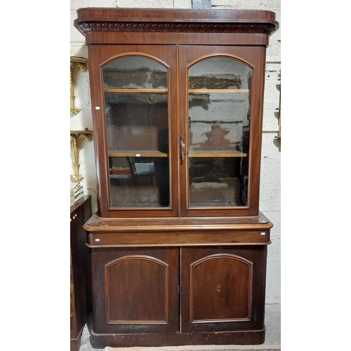 1041 - A Victorian mahogany Bookcase, with moulded cornice above two arched and glazed doors, long frieze d... 