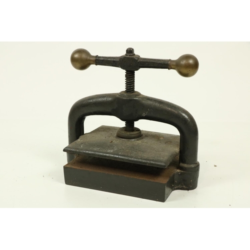 1047 - A very heavy cast iron Book Press, with brass ball mounted handle, 17