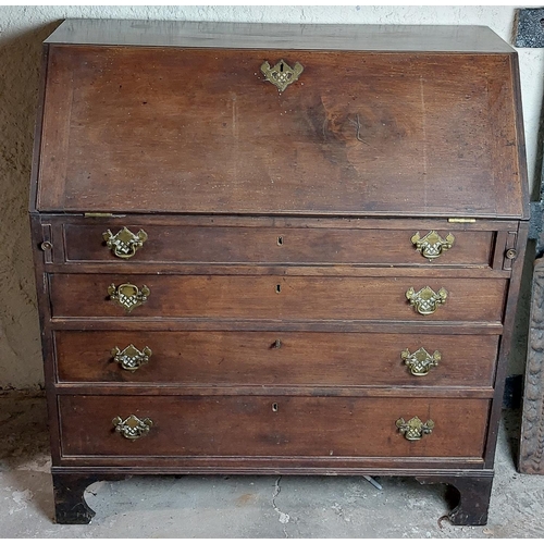 1054 - A Georgian period Irish mahogany slope front Bureau, of plain design, the top opening to reveal a fi... 