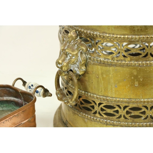 1059 - A heavy oval pierced brass Wastepaper Bin or Turf Holder, with lion mask and ring handles, 12