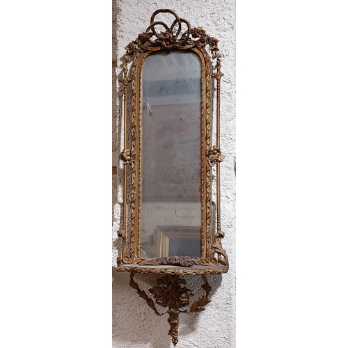 1081 - A 19th Century gilt Pier Mirror, with arched top crested with a ribbon bow and flower head on a ribb... 