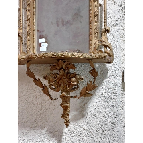 1081 - A 19th Century gilt Pier Mirror, with arched top crested with a ribbon bow and flower head on a ribb... 