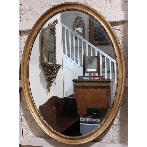 1101 - A 19th Century large giltwood oval Mirror, with beaded edge and moulded side, approx. 112cms x 84cms... 