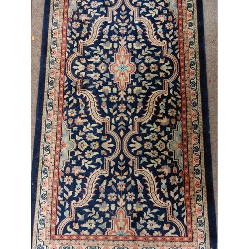 1109 - An antique style heavy woollen Indian Carpet, by 'Kaleen' the dark blue ground with multiple medalli... 