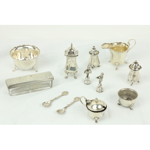 622 - A small silver Sugar & Cream, some silver Condiments, two small silver Figurines, a silver toppe... 