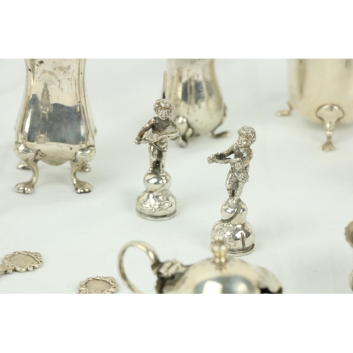 622 - A small silver Sugar & Cream, some silver Condiments, two small silver Figurines, a silver toppe... 