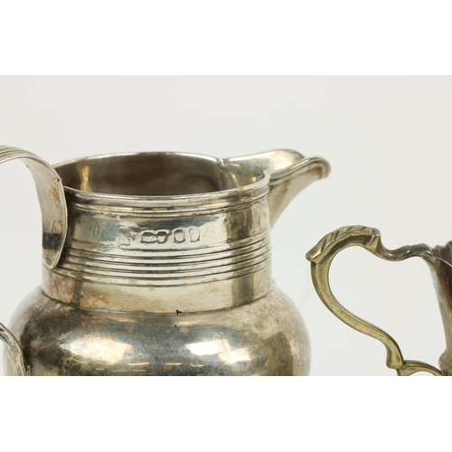 626 - Three English silver Cream Jugs, two with half reeded bodies, and one with paw feet. (3)... 