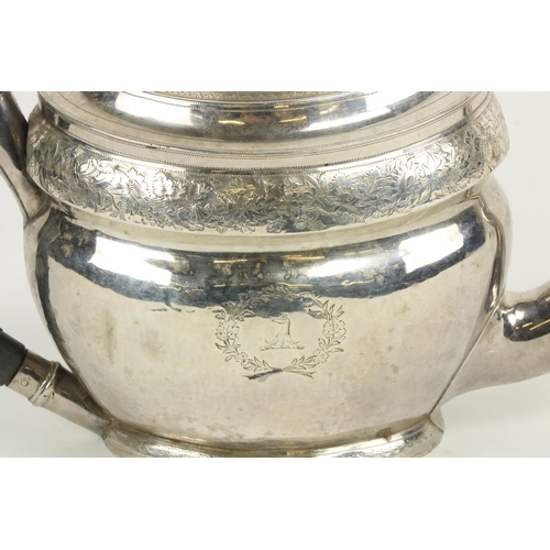 630 - A large boat shaped oval English silver Teapot, with bright cut decoration and armorial crests, Lond... 