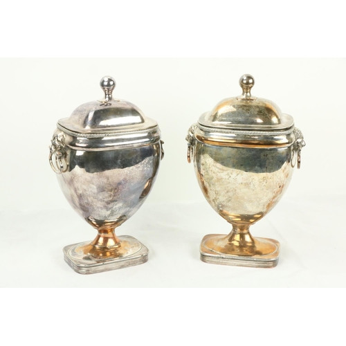 646 - A pair of Old Sheffield silver plated Urns and Covers, each with two lion mask and ring handles and ... 