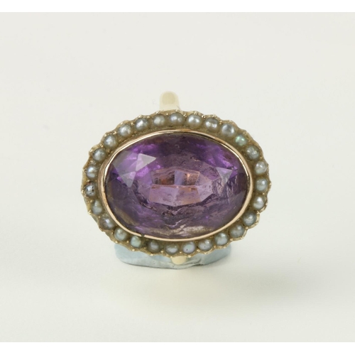 788 - An good large rare purple tourmaline cut oval Stone, set with gold mount surround and 26 pearls, on ... 