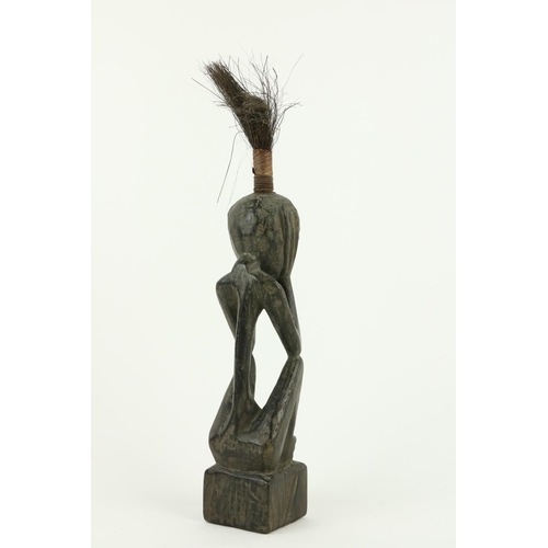 852 - An antique hardwood sculptured Figure, 