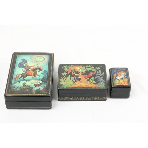 855 - Three Russian lacquered Boxes, each cover decorated with legends and fairy tales, 5 1/4