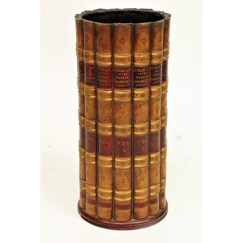 875 - A cylindrical composition Stick Stand, modelled with faux leather book spines, 19 1/2' (50cms). (1)... 