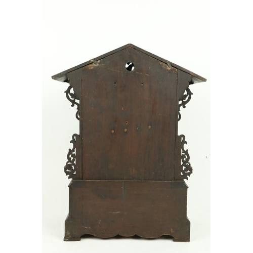 879 - A German carved wooden Cuckoo Clock, Black Forest with arched top and circular dial with Roman numer... 