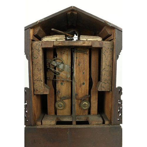 879 - A German carved wooden Cuckoo Clock, Black Forest with arched top and circular dial with Roman numer... 