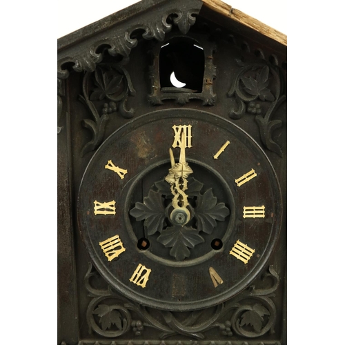 879 - A German carved wooden Cuckoo Clock, Black Forest with arched top and circular dial with Roman numer... 