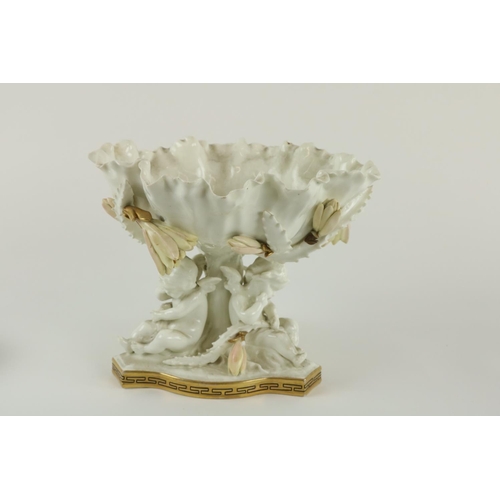 913 - A Moore Brothers Cacti Centerpiece, 19th Century , with three cherubs, supporting a bowl with flower... 