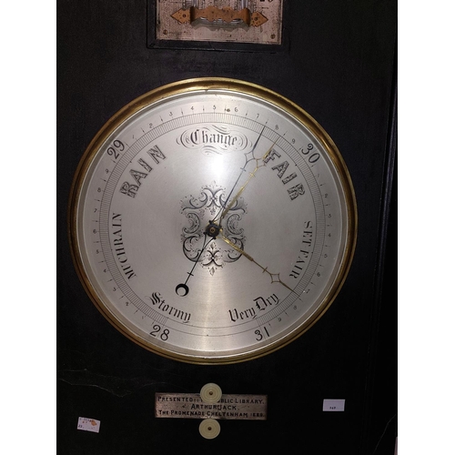 969 - A late Victorian ebonised Barometer and Thermometer, with silvered dials, and bone turned handles, w... 