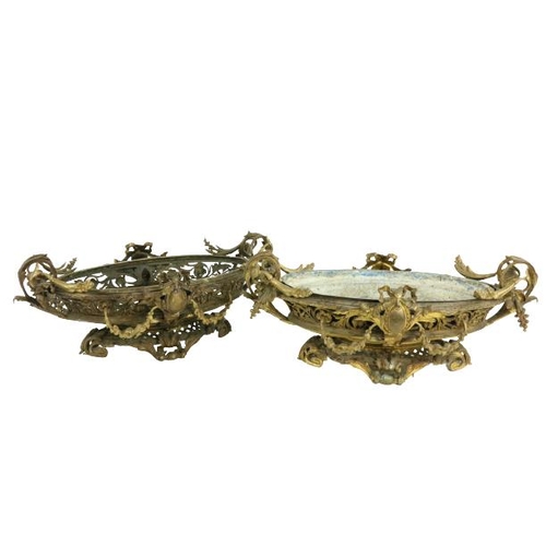 250 - A good pair of French bronze and gilt bronze oval Jardinières, each in the rococo style with scrolli... 