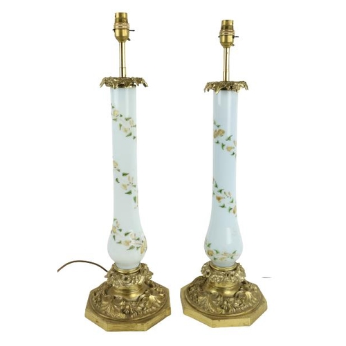 409 - A good pair of leaf cast brass Table Lamps, with light blue baluster glass stems decorated with flow... 