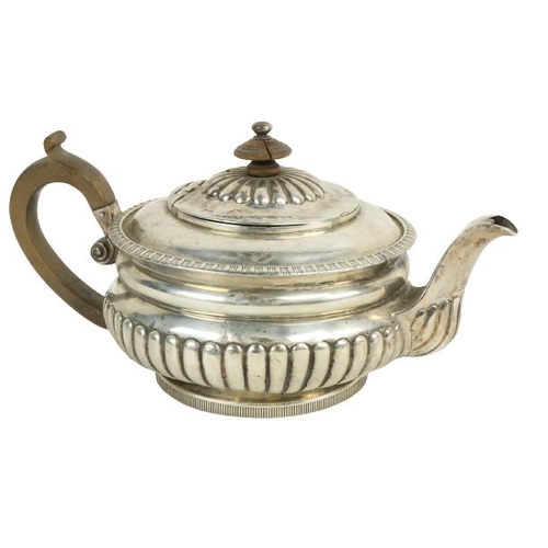 629 - A Georgian silver Teapot, with wooden handle and knob, London, c. 1815, with half reeded body. (1)... 