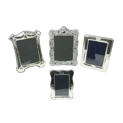 635 - A rectangular silver mounted Photograph Frame, two large white metal Photograph Frames, and another ... 