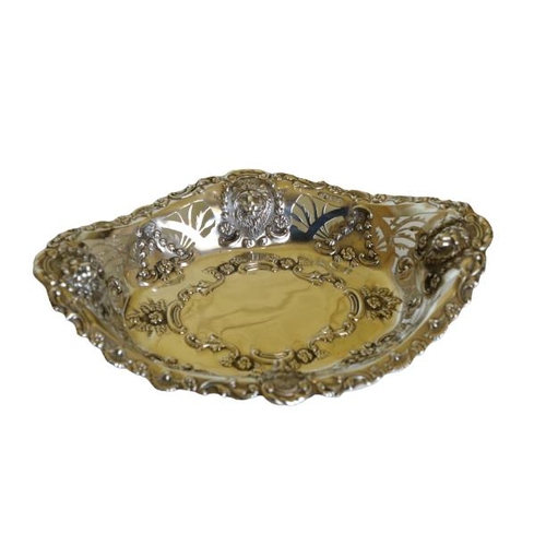 664 - An attractive pierced and embossed oval silver Bon Bon Dish, decorated with lion masks, and floral g... 