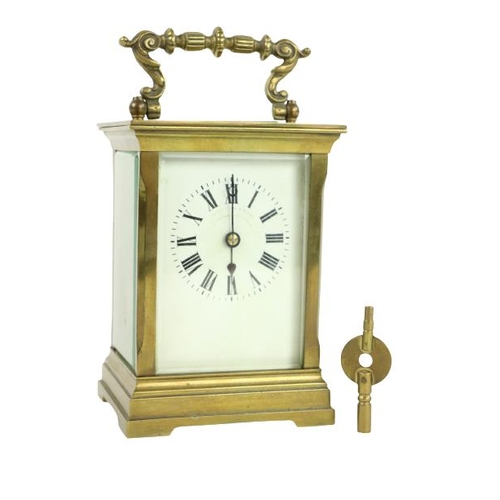 748 - A heavy brass five glass French Carriage Clock, the white dial with Roman numerals and with swing ha... 