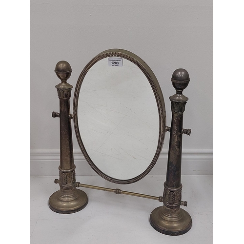 1203 - A silver plated oval swing frame Dressing Table Mirror, with upward tapering column supports on two ... 