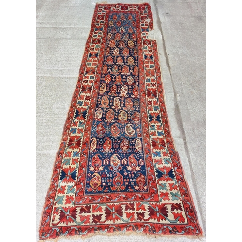 1589 - An antique silk Middle Eastern Carpet Runner, the blue ground with geometric design and stylised flo... 