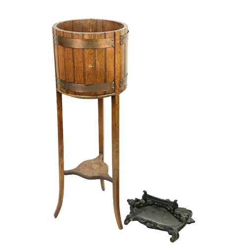 496 - A heavy cast iron black painted Footscrapper, together with an oak copper bound Plant Stand on three... 