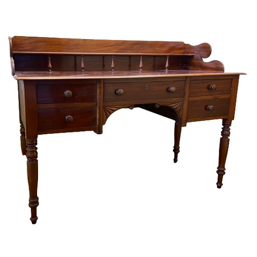 9 - A William IV period mahogany Dressing Table, with three quarter gallery with shelf on baluster turne... 